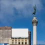 The Dewey Monument rises above Union Square, topped by a bronze figure holding a staff and wreath.