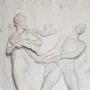 White marble relief on the Borghese Vase showing a draped woman and a nude man pulling at flowing fabric.
