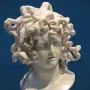 Bernini\'s Medusa, a marble bust with a downcast face and snakes carved as hair.