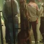 The Shigir Idol, a tall carved wooden artifact displayed upright in a glass case.