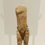 Immodest Venus ivory female figurine on a dark stand with silver-toned clips