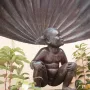 Jeanneke Pis, a bronze statue of a crouching girl smiling beneath a stream of water.