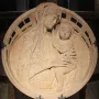Madonna del Perdono relief showing the Madonna holding the child beneath a decorated arch