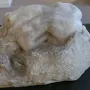 Rodin\'s Danaid sculpture showing a nude figure bent low over a rough base.