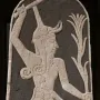 Stele of Baal with a horned deity raising a thunderbolt and holding a spear, with a smaller figure beside him.