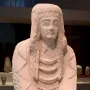 Lady of Cerro de los Santos stone statue holding a small vessel with both hands