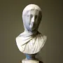 The Veiled Nun sculpture showing a veiled marble bust with the face softly visible beneath draped fabric.