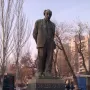 Bronze statue of Avetik Isahakyan standing on a stone pedestal in Yerevan.