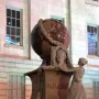 Daguerre Memorial stone sculpture with a bust of Daguerre, a large globe, and a draped female figure with a laurel garland.