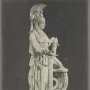 Varvakeion Athena shown in profile, holding a small winged figure beside a shield and column.