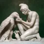 Ganymede with Jupiter\'s Eagle marble sculpture of a kneeling young man offering a dish to an eagle.