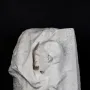 Octave Mirbeau plaster bust in profile, facing left with an open mouth, emerging from a rough draped block.