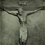 Santa Croce Crucifix showing a wooden Christ figure on the cross with bowed head, halo, loincloth, and INRI plaque above.