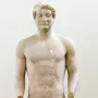 Aristodikos Kouros, a nude marble male statue with short curly hair and broken arms on a rectangular base.
