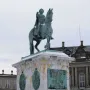 Frederick V equestrian statue on a marble pedestal with chain fencing in a snowy square