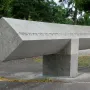 Klagebalken memorial with a long stone beam balanced on a central block outdoors.