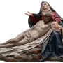Pietà sculpture in polychrome wood showing the Virgin Mary supporting the lifeless body of Christ.