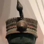 Bronze Head from Ife with fine vertical facial striations, closed eyes, and an elaborate headdress.