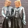 Goethe and Schiller Monument with both figures wearing paper bags over their heads with smiley faces drawn on them.