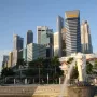 The Merlion statue spouting water with Singapore’s skyline behind it.