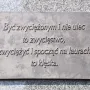 Bronze plaque with raised Polish text on the Józef Piłsudski Monument.