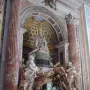 Tomb of Pope Alexander VII with a seated figure at the top, draped statues below, and a skeleton emerging from the base holding an hourglass.