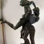 Hercules and Antaeus bronze sculpture showing two muscular figures in a struggle on a marble pedestal.