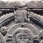 Close-up of the Rachis Altar relief showing a haloed face, an outstretched hand, and carved floral patterns.