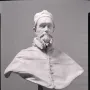 White marble bust of Pope Innocent X on a pedestal against a dark background.