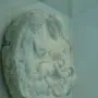 Taddei Tondo marble relief with a seated woman, an infant, and a standing youth.