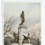 Tadeusz Kościuszko statue on a tall white pedestal with bronze figures and an eagle at the base.