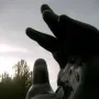 Botero’s Hand sculpture rising from a pedestal on a grassy median in Madrid