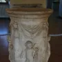 Four Seasons Altar with carved marble reliefs, draped swags, and putti holding flowers and grapes.