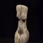 Venus of Eliseevichi figurine with an elongated form, prominent hips and breasts, and a featureless head