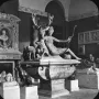 Black-and-white photograph of Diana with a stag sculpture, showing a reclining female figure beside a deer with large antlers in an interior gallery.