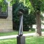 Große zwei V, a dark abstract bronze sculpture with two angled columns and a split spherical top outdoors.
