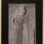 Stone relief of Mourning Athena, shown with her head bowed and leaning on a spear beside a rectangular stele.
