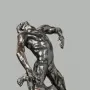The Falling Man bronze sculpture showing a male figure arching backward on a block-like base.
