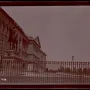 Equestrian statue of General Joseph Hooker in front of a classical building and iron fence.