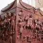 Red porphyry Sarcophagus of Helena carved with mounted soldiers, figures, and garland decoration.