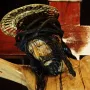 Close-up of Cristo de La Laguna showing the bowed head, closed eyes, crown of thorns, and gilded halo of the wooden crucifix.
