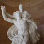Mercury and Psyche sculpture showing a muscular male figure lifting a draped female figure against a curved stone wall.