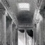Black and white drawing of the Bassae Frieze in a long colonnaded temple interior.