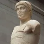 Motya Charioteer marble sculpture showing a worn head, draped torso, and missing arms.