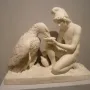 Ganymede with Jupiter\'s Eagle marble sculpture of a kneeling young man offering a dish to an eagle.