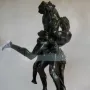 Hercules and Antaeus bronze sculpture showing two muscular figures in a struggle on a marble pedestal.