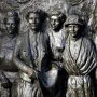 Bronze relief of six women on the Kate Sheppard National Memorial, with the central figure holding a rolled document.
