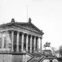 Frederick William IV equestrian statue in front of a classical building with columns and a sculpted frieze.