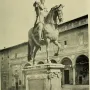 Ferdinando I de\' Medici equestrian statue showing a bearded armored rider on a horse atop a tall pedestal.