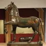 Bronze horse statue from the Neuvy-en-Sullias Hoard, shown with one front leg raised on a rectangular base.